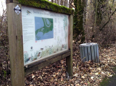 Trail map and garbage can at Interlakes trailhead